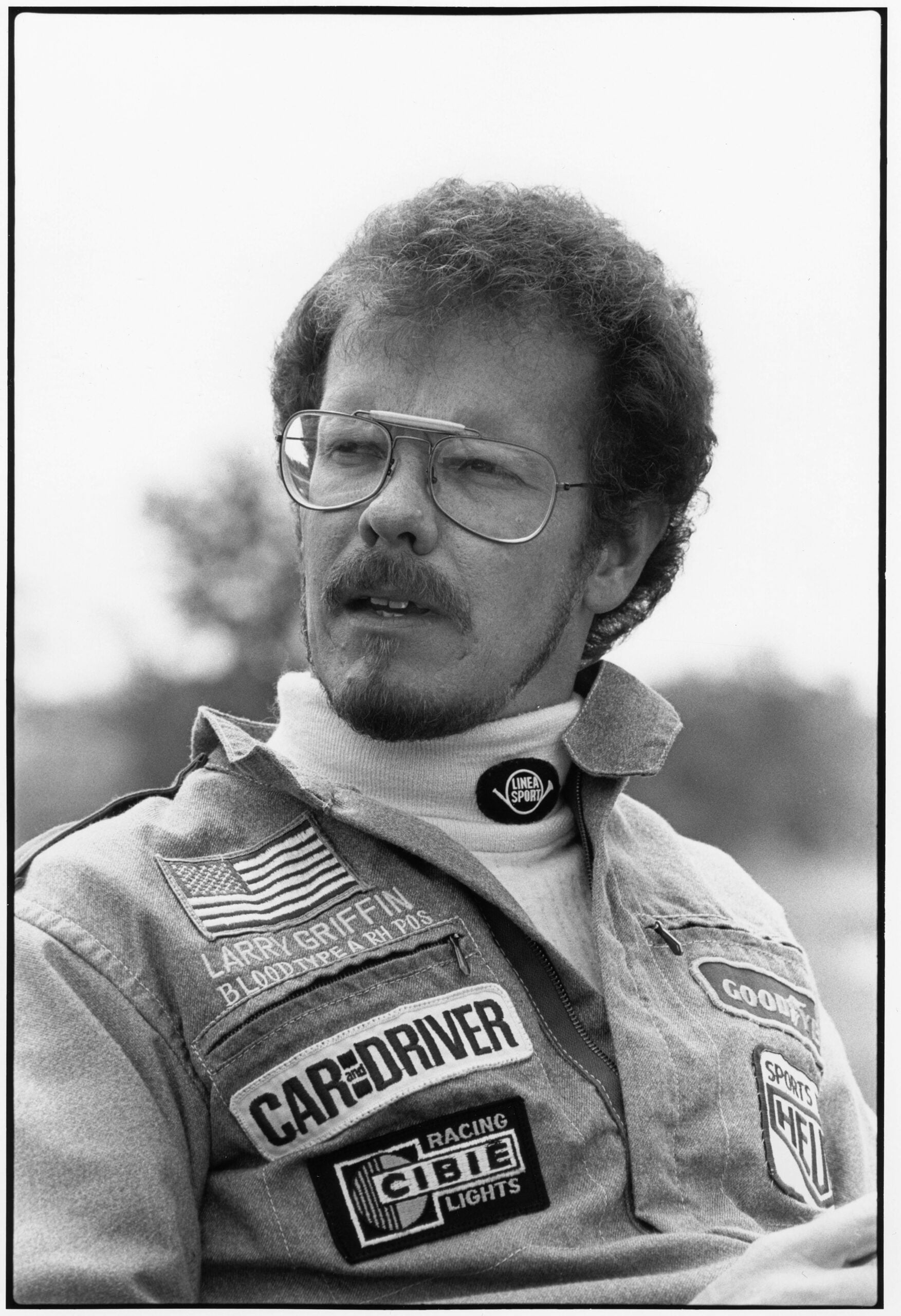 Larry Griffin in his Car and Driver racing jacket, smiling